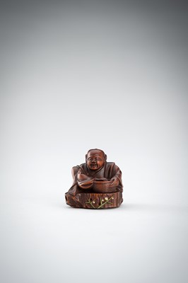 Lot 523 - RYUMIN: A WOOD NETSUKE OF HANASAKA-JIJI WITH A BASKET OF ASHES