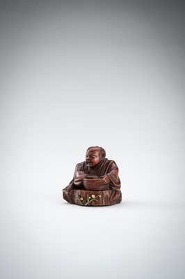 Lot 523 - RYUMIN: A WOOD NETSUKE OF HANASAKA-JIJI WITH A BASKET OF ASHES