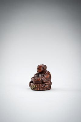 Lot 523 - RYUMIN: A WOOD NETSUKE OF HANASAKA-JIJI WITH A BASKET OF ASHES