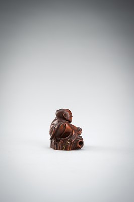 Lot 523 - RYUMIN: A WOOD NETSUKE OF HANASAKA-JIJI WITH A BASKET OF ASHES