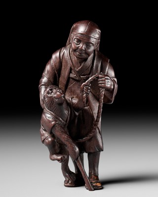 Lot 274 - TOSHICHIKA: A FINE TOKYO SCHOOL WOOD NETSUKE OF A SARUMAWASHI WITH MONKEY