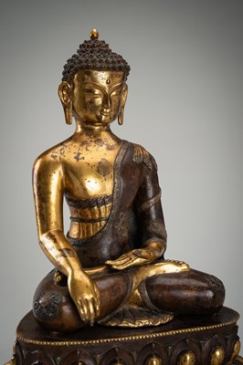 Lot 1559 - A LARGE PARCEL-GILT BRONZE FIGURE OF BUDDHA SHAKYAMUNI