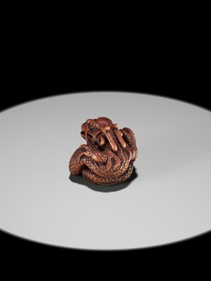 Lot 90 - MINKO: A POWERFUL WOOD NETSUKE OF A COILED DRAGON