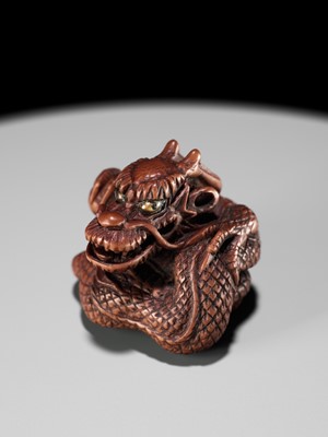 Lot 90 - MINKO: A POWERFUL WOOD NETSUKE OF A COILED DRAGON