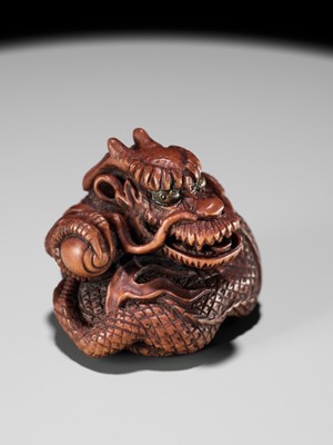 Lot 90 - MINKO: A POWERFUL WOOD NETSUKE OF A COILED DRAGON