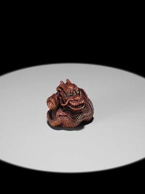 Lot 90 - MINKO: A POWERFUL WOOD NETSUKE OF A COILED DRAGON