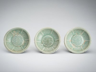 Lot 950 - THREE SMALL CELADON GLAZED AND MOLDED PORCELAIN DISHES, 12TH CENTURY