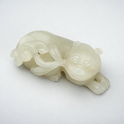 Lot 1771 - A PALE CELADON JADE PENDANT OF A RECUMBENT QILIN, QING DYNASTY