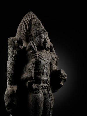 Lot 275 - A MONUMENTAL GRANITE FIGURE OF SHIVA AS BHAIRAVA, CHOLA PERIOD