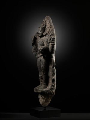 Lot 275 - A MONUMENTAL GRANITE FIGURE OF SHIVA AS BHAIRAVA, CHOLA PERIOD