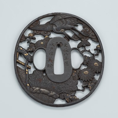 Lot 1497 - TAMAGAWA YOSHIKATSU: AN IRON SUKASHI TSUBA DEPICTING A CRANE AND MILLET SHEAF, DATED 1825