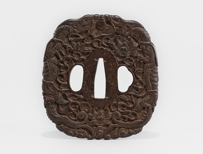 Lot 1519 - AN IRON TSUBA DEPICTING TWIN DRAGONS AND LOTUS BLOSSOMS