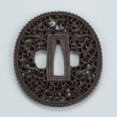 Lot 1550 - AN IRON TSUBA DEPICTING DRAGONS AND SCROLLING VINES