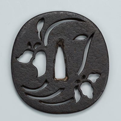 Lot 1535 - SADANOBU: AN IRON SUKASHI TSUBA WITH STYLIZED FLOWERS DESIGN