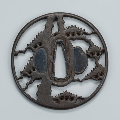 Lot 1538 - AN IRON SUKASHI TSUBA WITH A STYLIZED PINE TREE