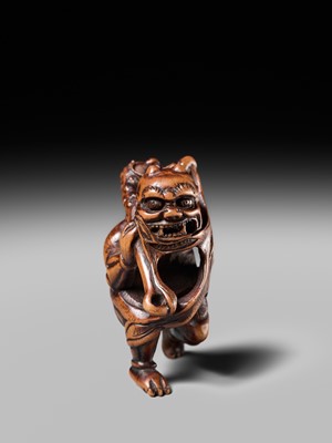 Lot 153 - A VERY RARE WOOD NETSUKE OF AN ONI CAUGHT IN A SPIDERWEB