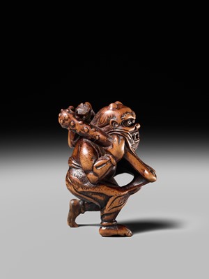 Lot 153 - A VERY RARE WOOD NETSUKE OF AN ONI CAUGHT IN A SPIDERWEB