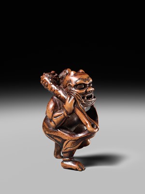 Lot 153 - A VERY RARE WOOD NETSUKE OF AN ONI CAUGHT IN A SPIDERWEB