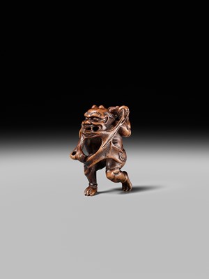 Lot 153 - A VERY RARE WOOD NETSUKE OF AN ONI CAUGHT IN A SPIDERWEB