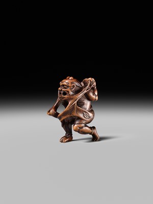 Lot 153 - A VERY RARE WOOD NETSUKE OF AN ONI CAUGHT IN A SPIDERWEB