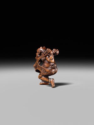 Lot 153 - A VERY RARE WOOD NETSUKE OF AN ONI CAUGHT IN A SPIDERWEB