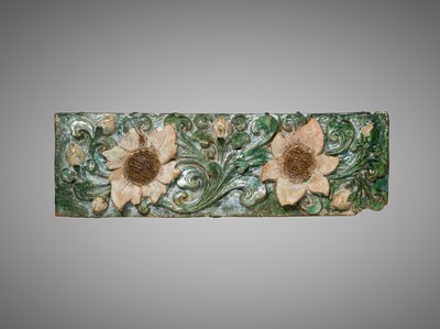 A LARGE GREEN-GLAZED ARCHITECTURAL POTTERY TILE DEPICTING LOTUS BLOSSOMS, MING DYNASTY