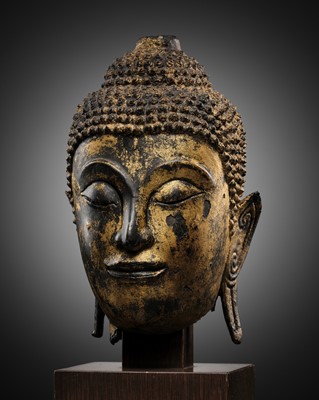 Lot 692 - A GILT-BRONZE HEAD OF BUDDHA, KINGDOM OF AYUTTHAYA (1351 - 1767)