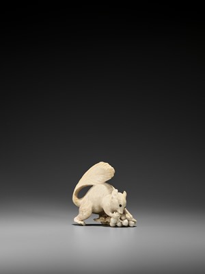 Lot 224 - EIICHI: AN IVORY OKIMONO OF A SQUIRREL GNAWING AT GRAPES