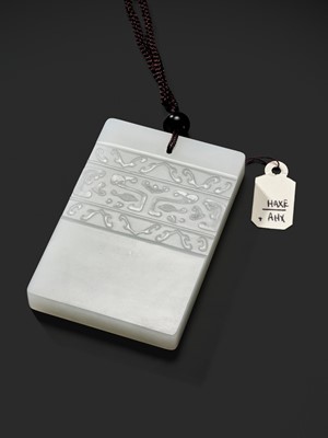 Lot 466 - A WHITE JADE ‘TAOTIE’ PENDANT, 19TH CENTURY