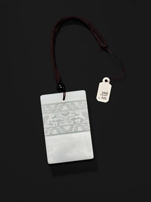 Lot 466 - A WHITE JADE ‘TAOTIE’ PENDANT, 19TH CENTURY