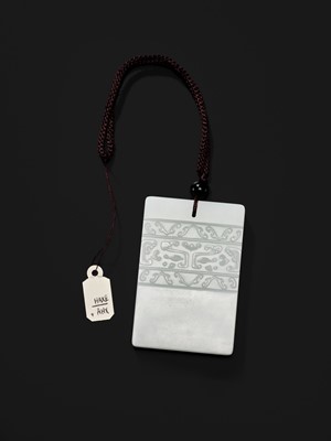 Lot 466 - A WHITE JADE ‘TAOTIE’ PENDANT, 19TH CENTURY