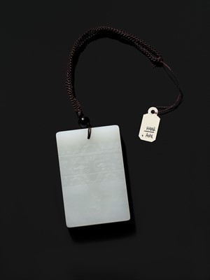 Lot 466 - A WHITE JADE ‘TAOTIE’ PENDANT, 19TH CENTURY