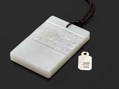 Lot 466 - A WHITE JADE ‘TAOTIE’ PENDANT, 19TH CENTURY