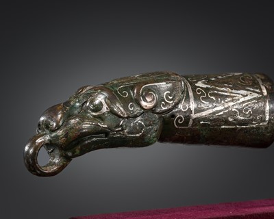 Lot 61 - A SILVER-INLAID BRONZE ‘TIGER’ FERRULE, WARRING STATES PERIOD