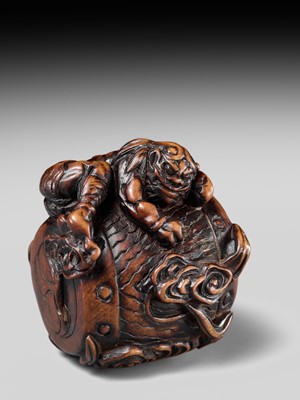 Lot 152 - A FINE NAGOYA SCHOOL WOOD NETSUKE OF RAIJIN SLEEPING ON HIS THUNDER DRUM