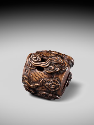 Lot 152 - A FINE NAGOYA SCHOOL WOOD NETSUKE OF RAIJIN SLEEPING ON HIS THUNDER DRUM