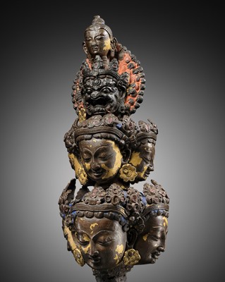 Lot 17 - A RARE TIBETAN GILT-BRONZE FRAGMENT WITH EIGHT HEADS OF AVALOKITESHVARA SAHASRABHUJA EKADASAMUKHA, 16TH CENTURY