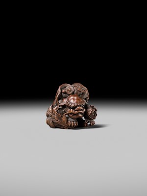 Lot 184 - SUKETADA: A SUPERB WOOD NETSUKE OF A SHISHI WITH PEONY