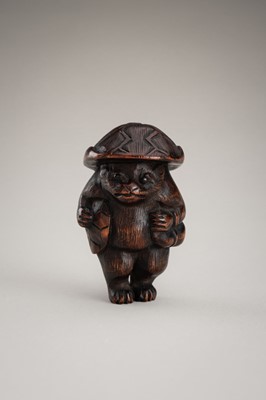 Lot 462 - A WOOD NETSUKE OF A TANUKI DISGUISED AS A SAKE VENDOR