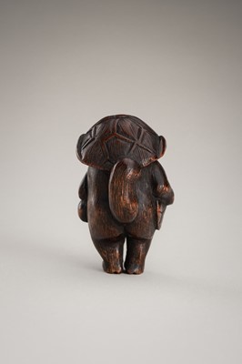 Lot 462 - A WOOD NETSUKE OF A TANUKI DISGUISED AS A SAKE VENDOR