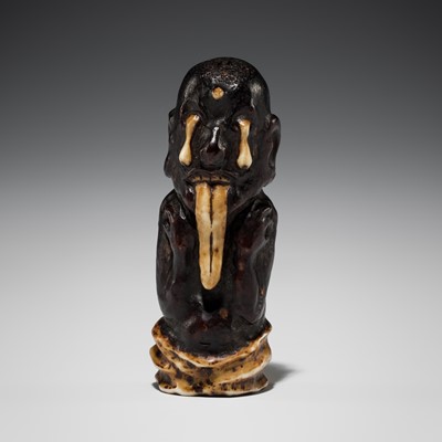 Lot 469 - A STAINED STAG ANTLER NETSUKE OF A BAKEMONO