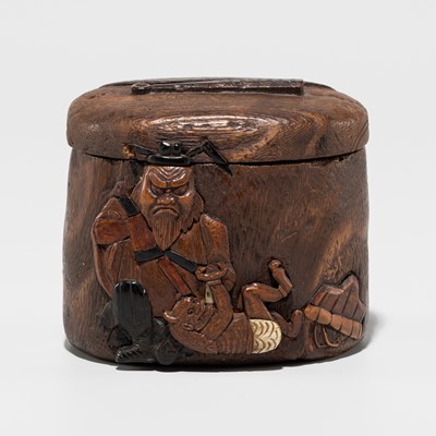 Lot 253 - JAKUO: AN INLAID WOOD TONKOTSU WITH SHOKI AND ONI