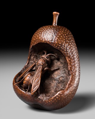 Lot 175 - KOGETSU: A SUPERB NAGOYA SCHOOL NETSUKE OF A WASP INSIDE A DECAYING PEAR