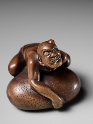 Lot 188 - SHOKO: A SUPERB WOOD NETSUKE OF A BLIND MAN LIFTING A CHIKARAISHI