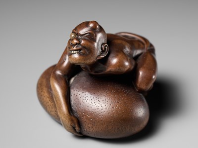 Lot 188 - SHOKO: A SUPERB WOOD NETSUKE OF A BLIND MAN LIFTING A CHIKARAISHI