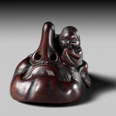 Lot 279 - AN AMUSING NAGOYA SCHOOL WOOD SHUNGA NETSUKE OF OKAME CARESSING A TENGU MASK