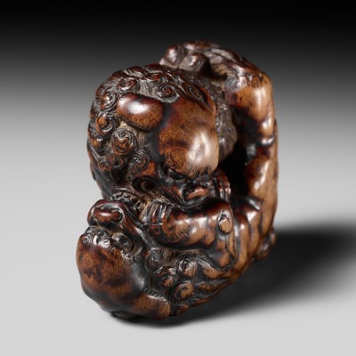 Lot 480 - TOMOHARU: A LARGE AND POWERFUL WOOD NETSUKE OF TWO SHISHI