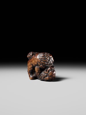 Lot 480 - TOMOHARU: A LARGE AND POWERFUL WOOD NETSUKE OF TWO SHISHI