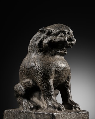 Lot 58 - A BLACK LIMESTONE FIGURE OF A SEATED LION, QING DYNASTY