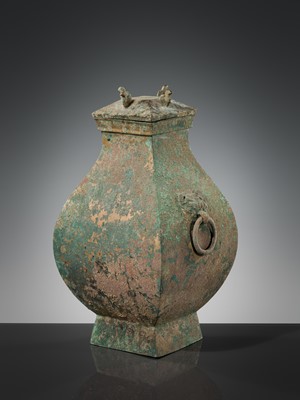 Lot 71 - A BRONZE STORAGE VESSEL AND COVER WITH BIRD-FORM FINIALS, FANGHU, HAN DYNASTY